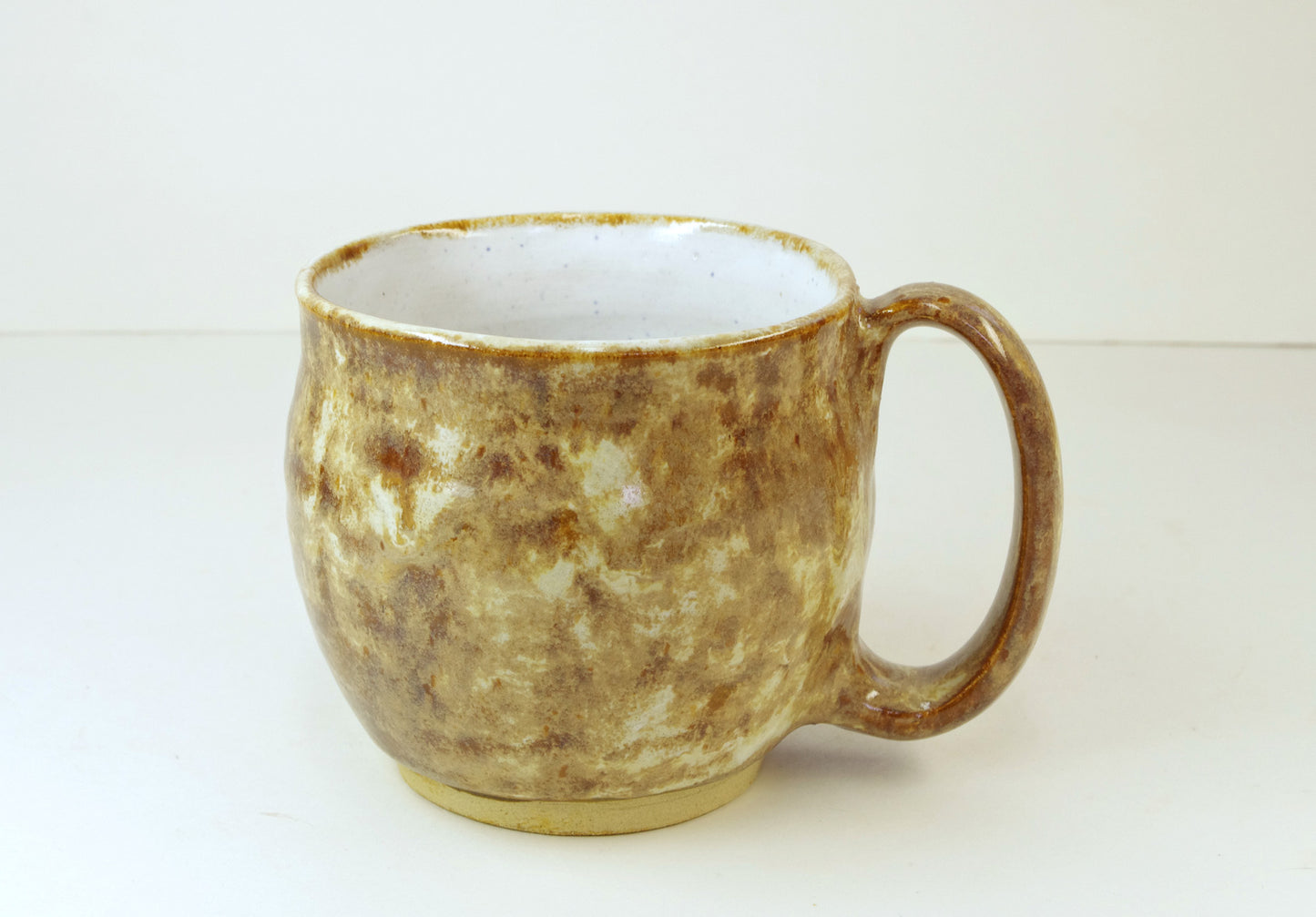 Hand thrown coffee mug handmade from stoneware, tans, browns, whitehorsepottery